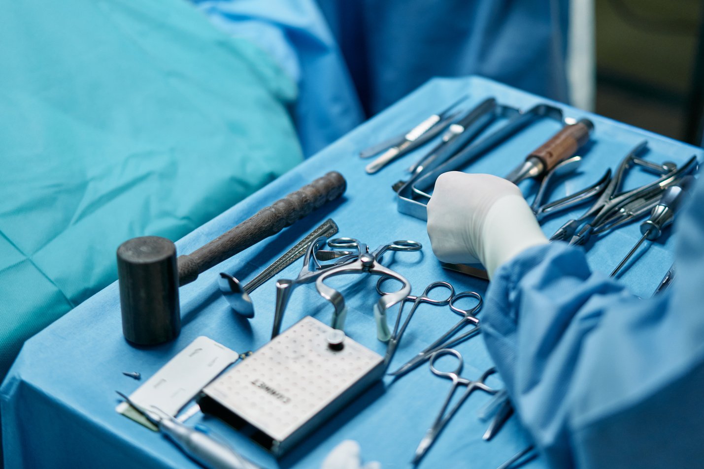 Person Holding Silver Medical Tool